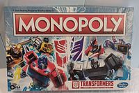 Box cover showing Monopoly Transformers edition with Optimus Prime and other Transformers graphics