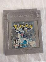 Front of gray Game Boy cartridge for Pokemon Silver Version showing label with Lugia and game title.
