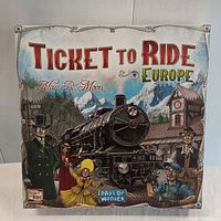 Closed box of Ticket to Ride Europe board game with illustrated cover showing a steam locomotive and characters, title and brand.