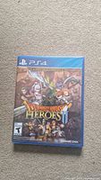 Front view of sealed Dragon Quest Heroes II PS4 game case showing artwork and ESRB rating T for Teen.