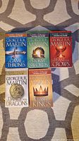 Front view of all five Game of Thrones books showing cover artwork and titles