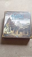 Closed box of Game of Thrones: The Board Game showing cover art with castle and surrounding landscape.