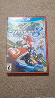 Front cover of Mario Kart 8 Wii U game case showing the game's title, Mario character in kart, and Nintendo branding