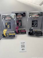 Three Power Rangers Action Micro Figures displayed side by side in their original sealed packaging showing Yellow, Pink, and Black Rangers.