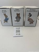 Photo of the three original boxes with character names Peter Rabbit, Tom Kitten, Jemima Puddle-Duck from The World of Beatrix Potter.