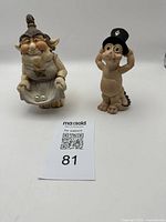 Image showing both troll figurines side by side on a white background, capturing overall appearance and size compared to auction card.
