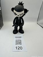 Front view of black and white ninja bear vinyl figurine standing upright showing facial details, armor buttons, and katana on back.