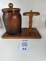 Front and partial side view of the cigar humidor and attached stand on a white background with MaxSold lot number card.