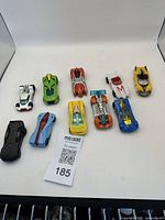 Top view of all nine die-cast model cars arranged in two rows showing variety and condition