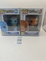 Both Funko Pop figures, Squirtle and Charmander, packaged in original boxes with clear windows, displayed side by side.