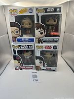 Set of four Funko Pop boxed figures: Elaine (Seinfeld), Captain Cassian Andor (Star Wars Target Exclusive), Poe Dameron, Rose (Star Wars)