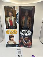 Front view of the boxed Qi'ra and Finn figures showing Star Wars branding and character images.