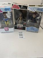 Photo of three Rock Candy vinyl figures including Belle, Enchantress, and Mary Poppins in original packaging with visible damage on two boxes
