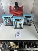 Three boxed buildable figurine sets from The Office series including Jim's Wedding, Dwight & Angela, and Schrute Farms.