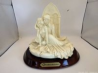 Front view of white alabaster Romeo and Juliet sculpture on wooden base with Faro Collection plaque visible