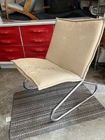 Front-right three-quarter view showing chrome frame and seat cushion with markings