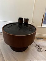 Side view of round wood veneer console on pedestal base