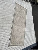 Full view of the 3'x8' runner rug laid flat showing overall pattern and coloring on a textured surface.