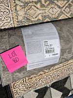 Label on rolled edge showing Lucia collection name, dimensions and materials