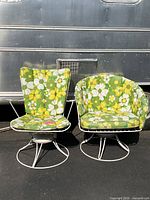 Front view of both chairs showing frame design and floral cushions