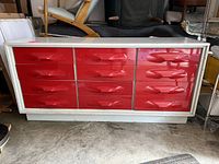 Full front view of nine-drawer dresser showing red fronts and white frame