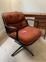 Front-angle view showing full chair profile, upholstery and base