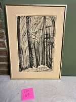 Framed black and white charcoal drawing showing abstract tall trees, signed lower right corner, frame has no glass.