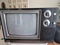 Front view of vintage Citizen television showing curved CRT screen, two tuning knobs and speaker grille.