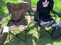 Front view of two camping chairs: brown and black with Canada design, showing armrests and cup holders.