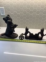 Lot shows all three vintage metal Scotty dog items together on a white surface with measuring tape for scale.