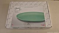 Box of Fiesta large serving platter in Meadow color showing front label and product image.