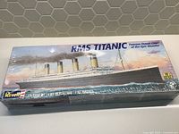 Front of the sealed box showing artwork of RMS Titanic ship in water with smoke stacks, scale indicated as 1:570.