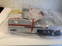 Scanner unit wrapped in clear plastic, showing overall shape and design, with Xerox logo visible at front.