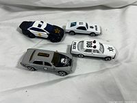 All four die-cast cars grouped together