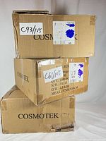 Stack of three COSMOTEK cardboard boxes showing quantity labels