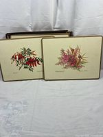 Two placemats displayed with box in background
