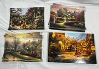 Stacks of various Thomas Kinkade 5x7 prints in four groups