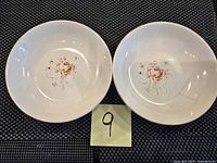 Two Rose Bower bowls placed side by side showing the rose floral design inside and visible cracks.