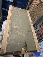 Top view of the travelling chest showing green painted surface with visible wear and some scratches.