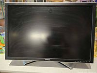 Front view of Dell widescreen LCD monitor with black bezel and stand, screen off.