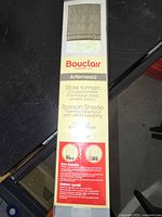 Photo of the Bouclair Artemesia Roman Shade packaging label showing product details such as thermal blackout with white backing and size 24x72 inches.