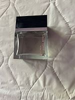 Front view of the Michael Kors For Men eau de toilette spray bottle showing clear glass container with black cap and product text.