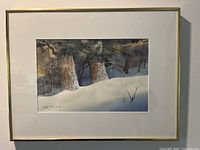 Full view of framed watercolour painting showing snowy tree trunks in winter landscape.