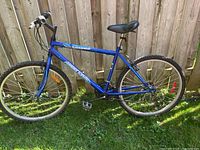 Side view of the blue Supercycle bicycle showing the full frame, tires, pedals, and seat.