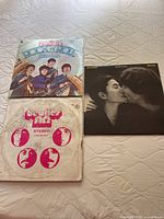 Photo of three Beatles vinyl albums: Rock 'n' Roll Music, Beatles Anthology, and Double Fantasy by John Lennon & Yoko Ono.