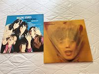 Front and back covers of two vintage Rolling Stones albums: 'Through the Past, Darkly' and 'Goats Head Soup'. Both vinyl album covers visible.