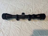 Side view of the full Weaver rifle scope showing overall length and mounting rings.