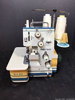 Front view of Baby Lock BL4-605 serger sewing machine with spools of thread visible on top and side.