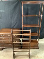 Three pieces of furniture included in the lot: a chest of drawers, a blanket rack, and a tall shelving unit, all shown together.