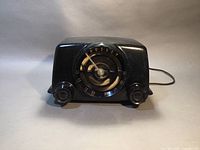 Front view showing curved Bakelite housing, central dial with Crosley logo and tuning pointer, left and right control knobs